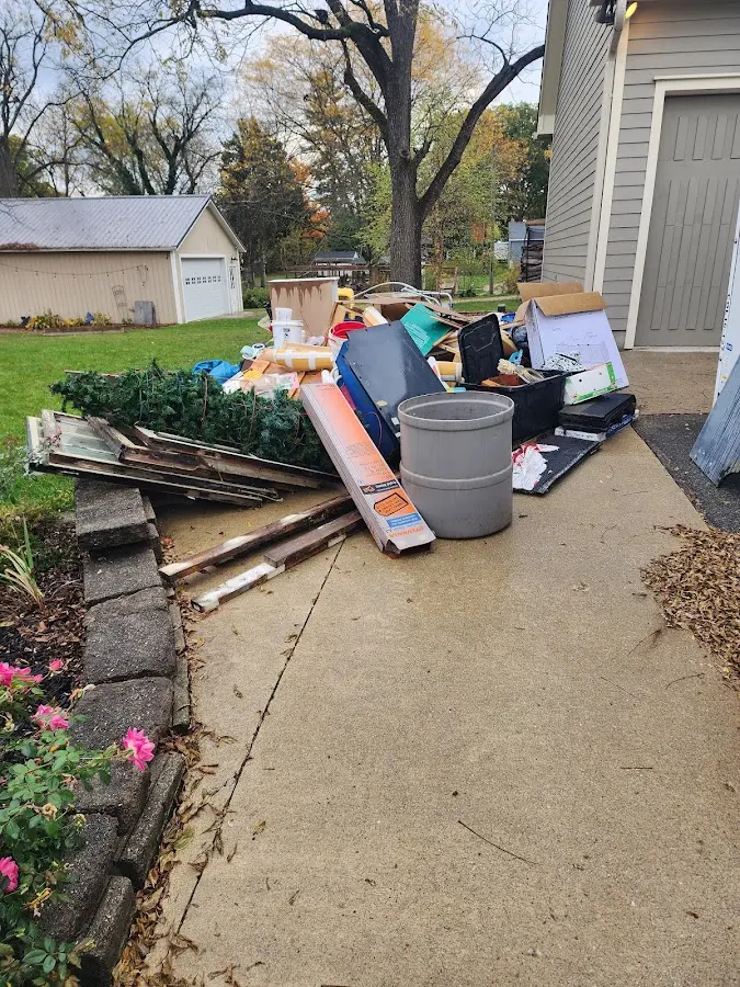 Dumpster being loaded with debris for Roofing Dumpster Rental in Dalton